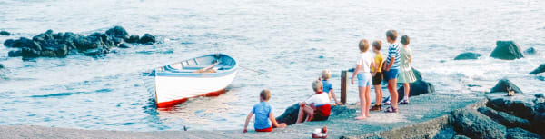 Children on a jetty looking out to sea.